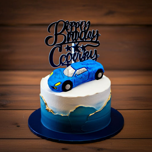 Elegant birthday cake with a blue sports car topper and gold detail, suitable for car lovers.