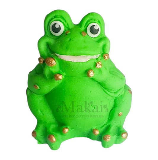 Green fondant frog cake decoration with gold spots front view