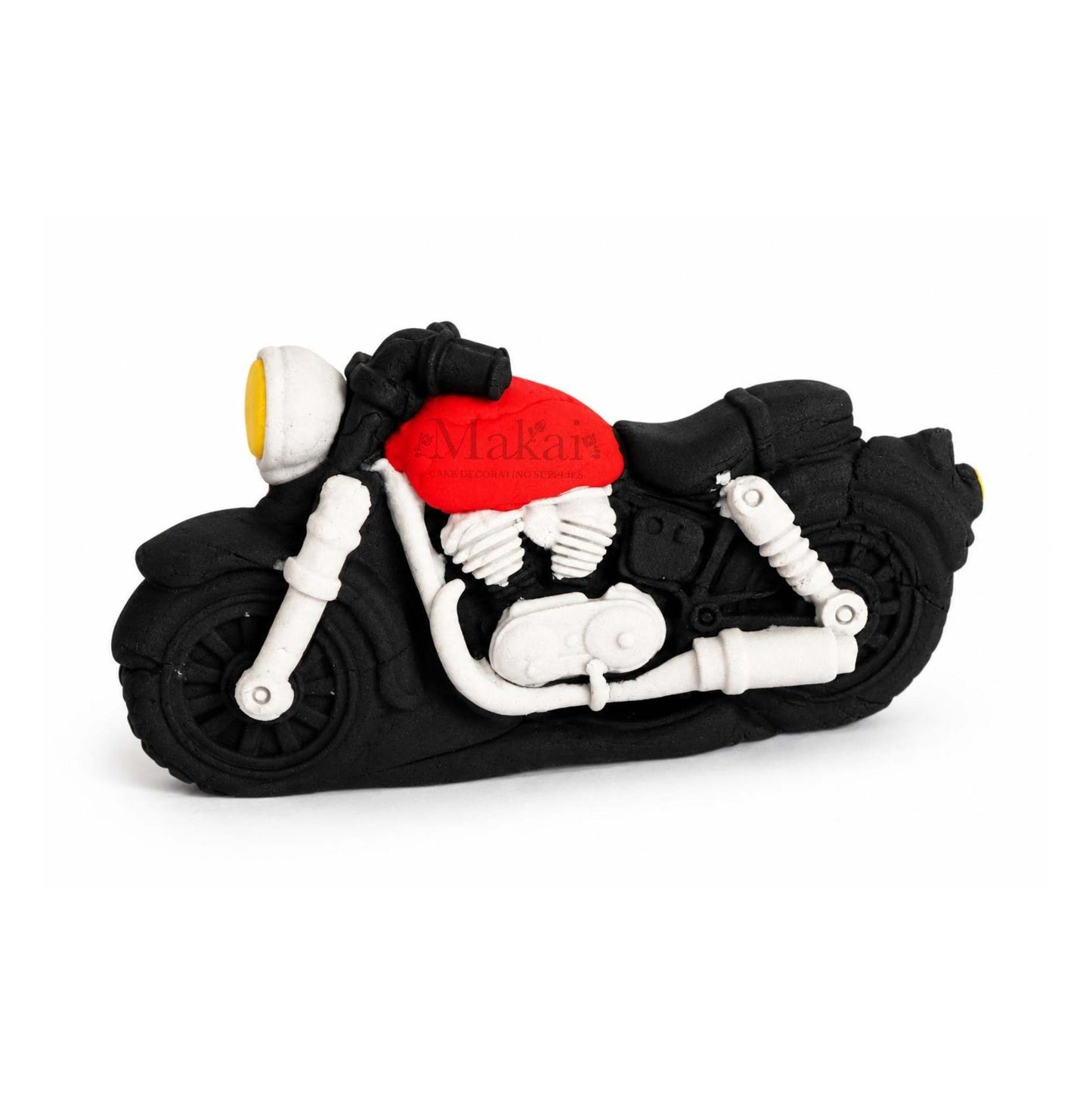 Motorcycle-shaped cake topper with a red top on a white background