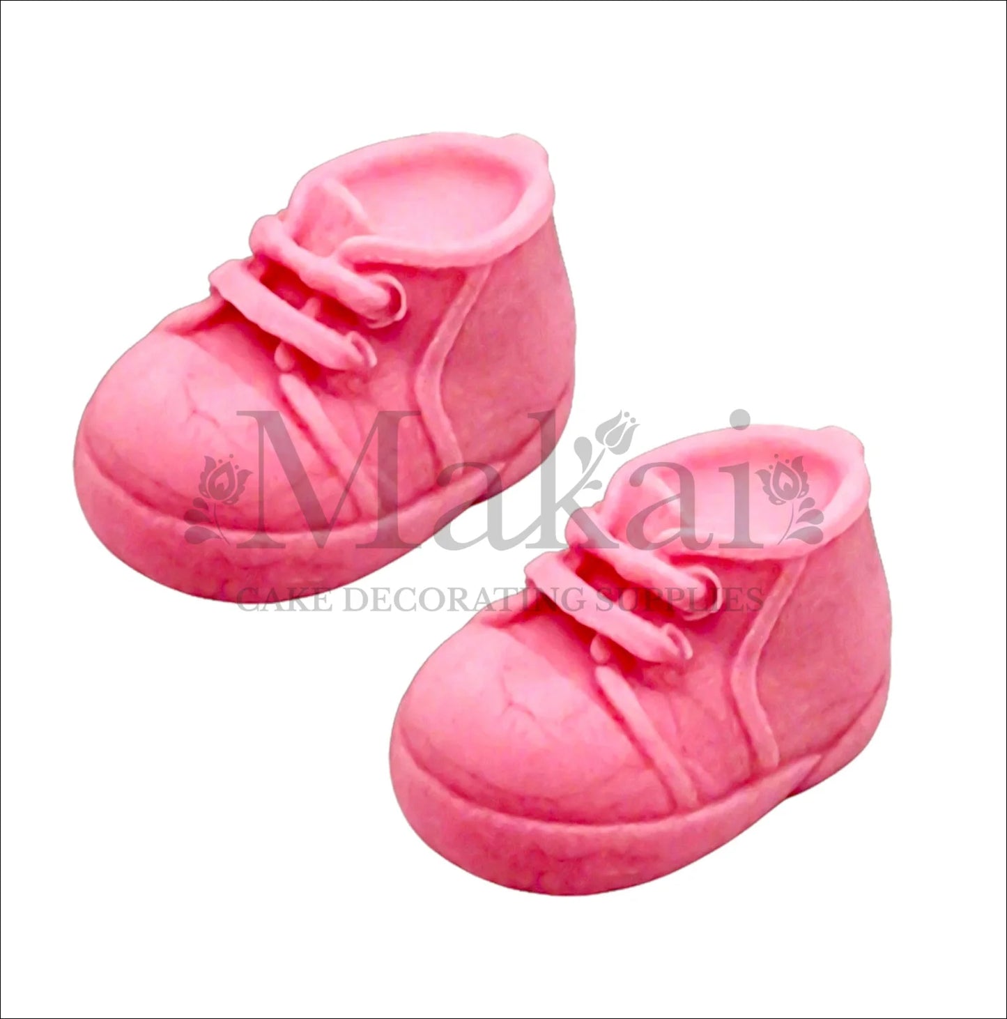 Edible fondant pink baby shoes cake topper set for girl baby‑shower and birthday cakes.