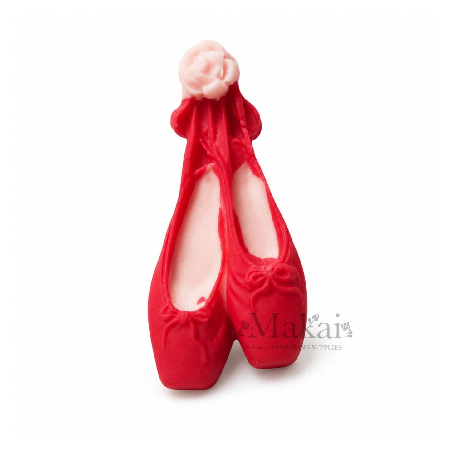 Pink ballerina shoe cake topper with ribbons for baby‑girl and dance‑themed cakes.