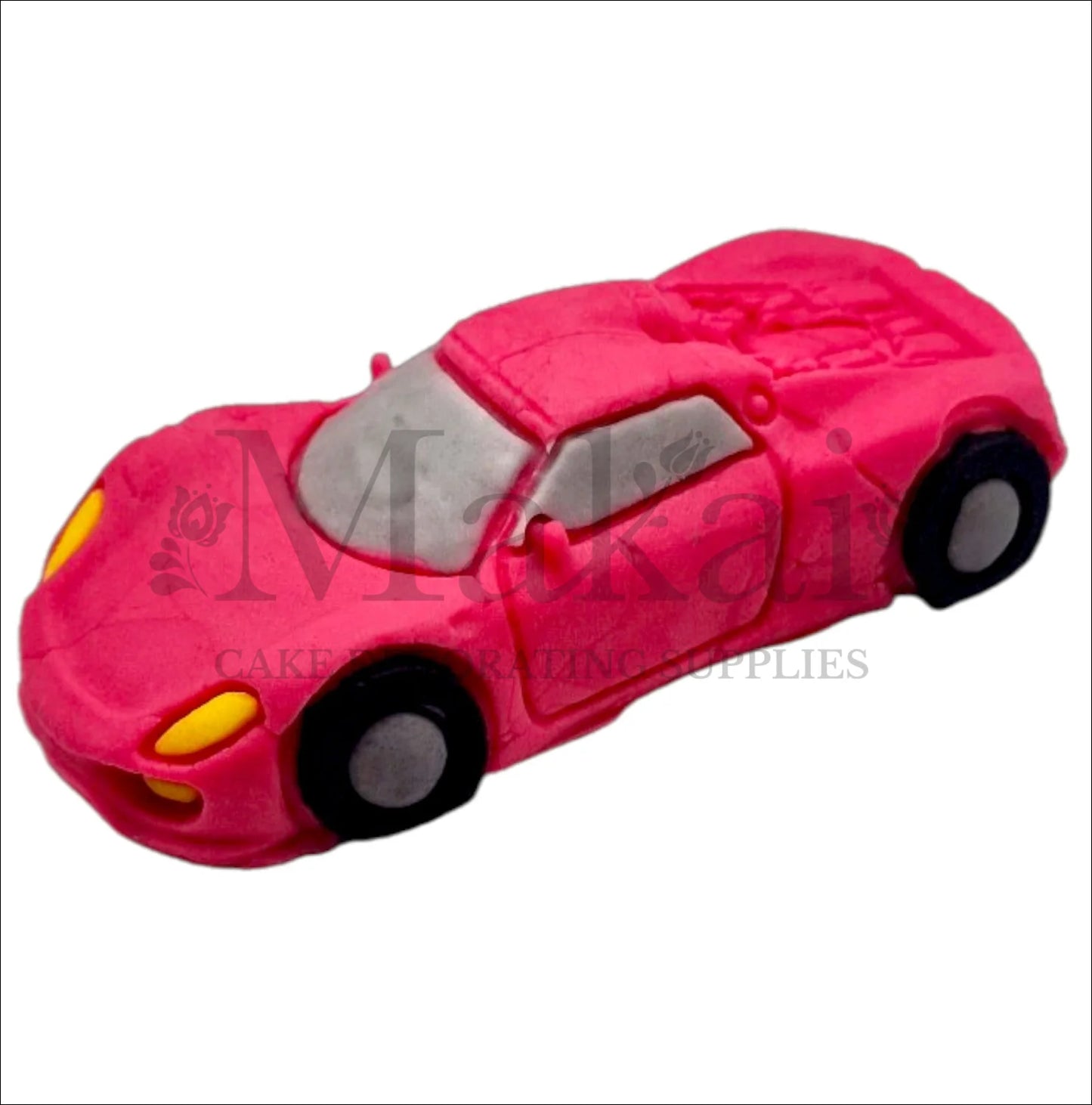Edible hot‑pink fondant sports car cake topper with black wheels and yellow headlights.