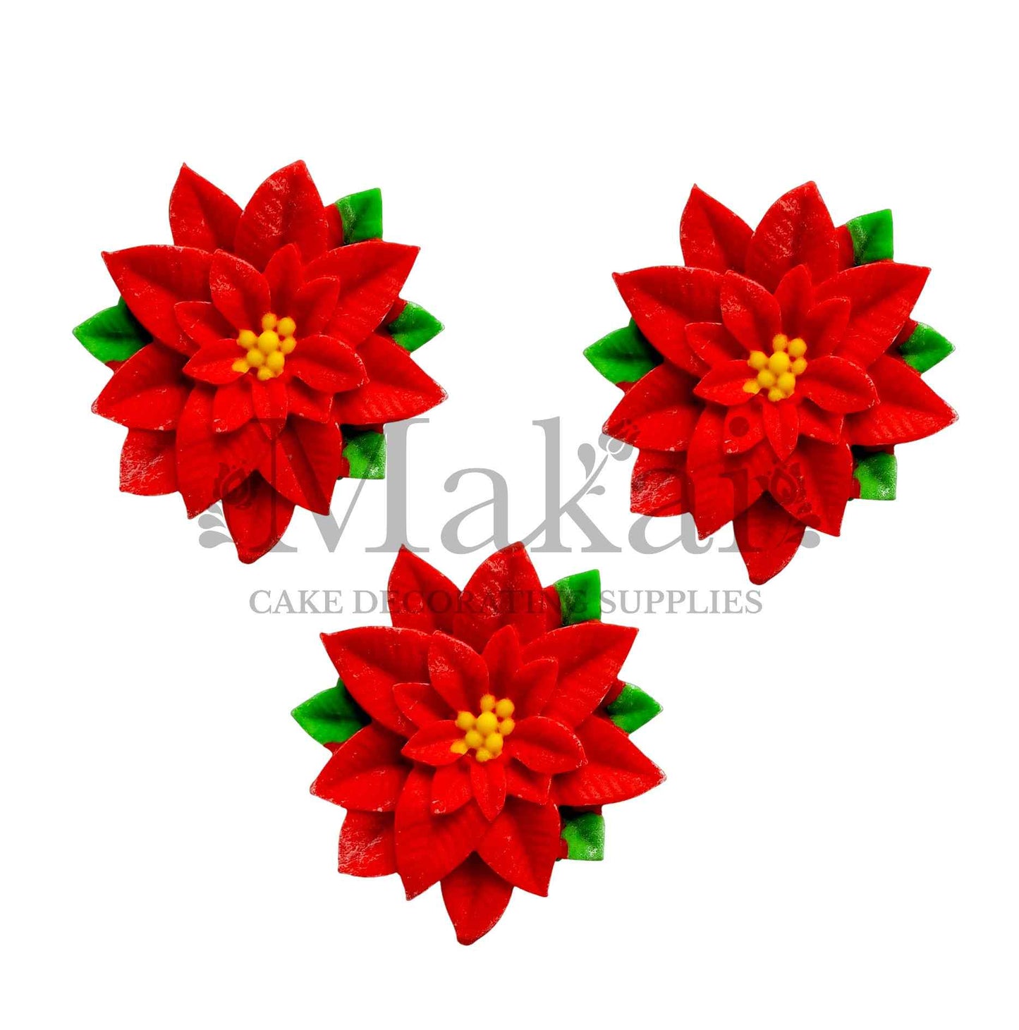 Red edible poinsettia flower cake toppers with layered petals and green leaves.