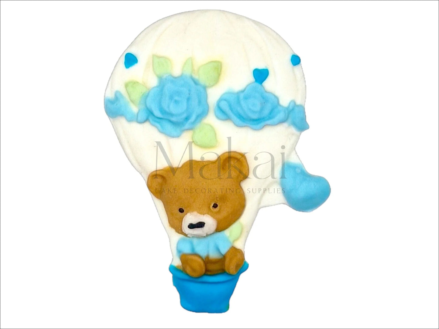 Blue fondant hot air balloon cake topper with teddy bear, roses, and heart details – edible decoration