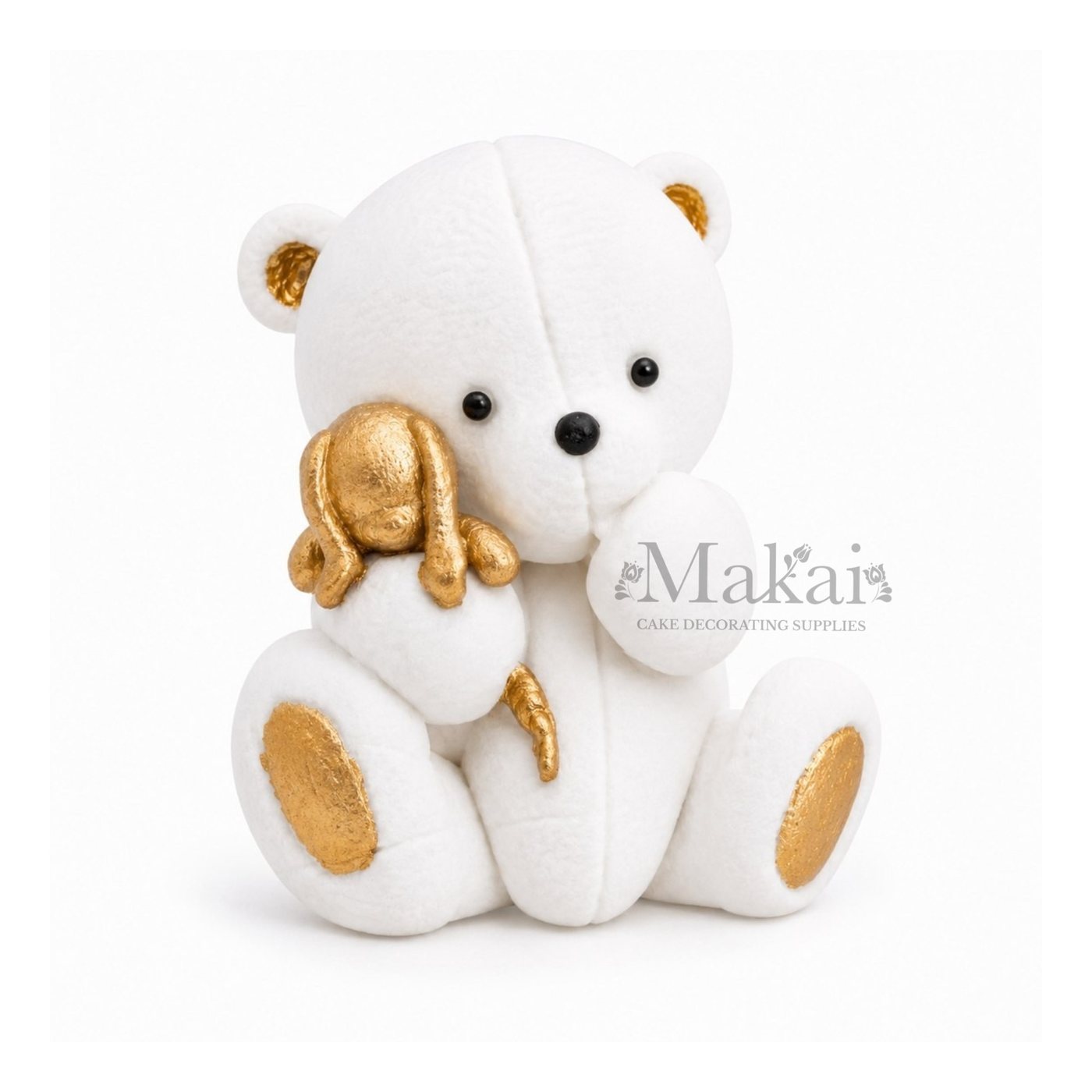 White teddy bear fondant cake topper holding a gold bunny decoration, front view