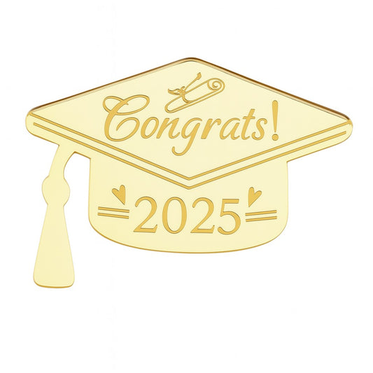 Gold acrylic cake topper in the shape of a graduation cap, engraved with “Congrats!” and “2025” with hearts and tassel