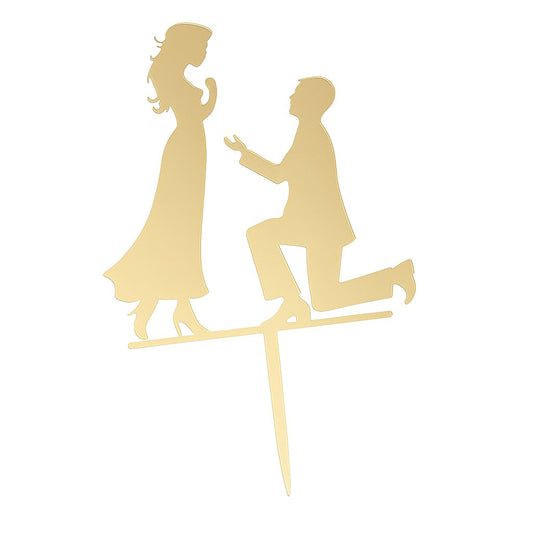 Gold acrylic cake topper showing groom kneeling in proposal pose in front of bride