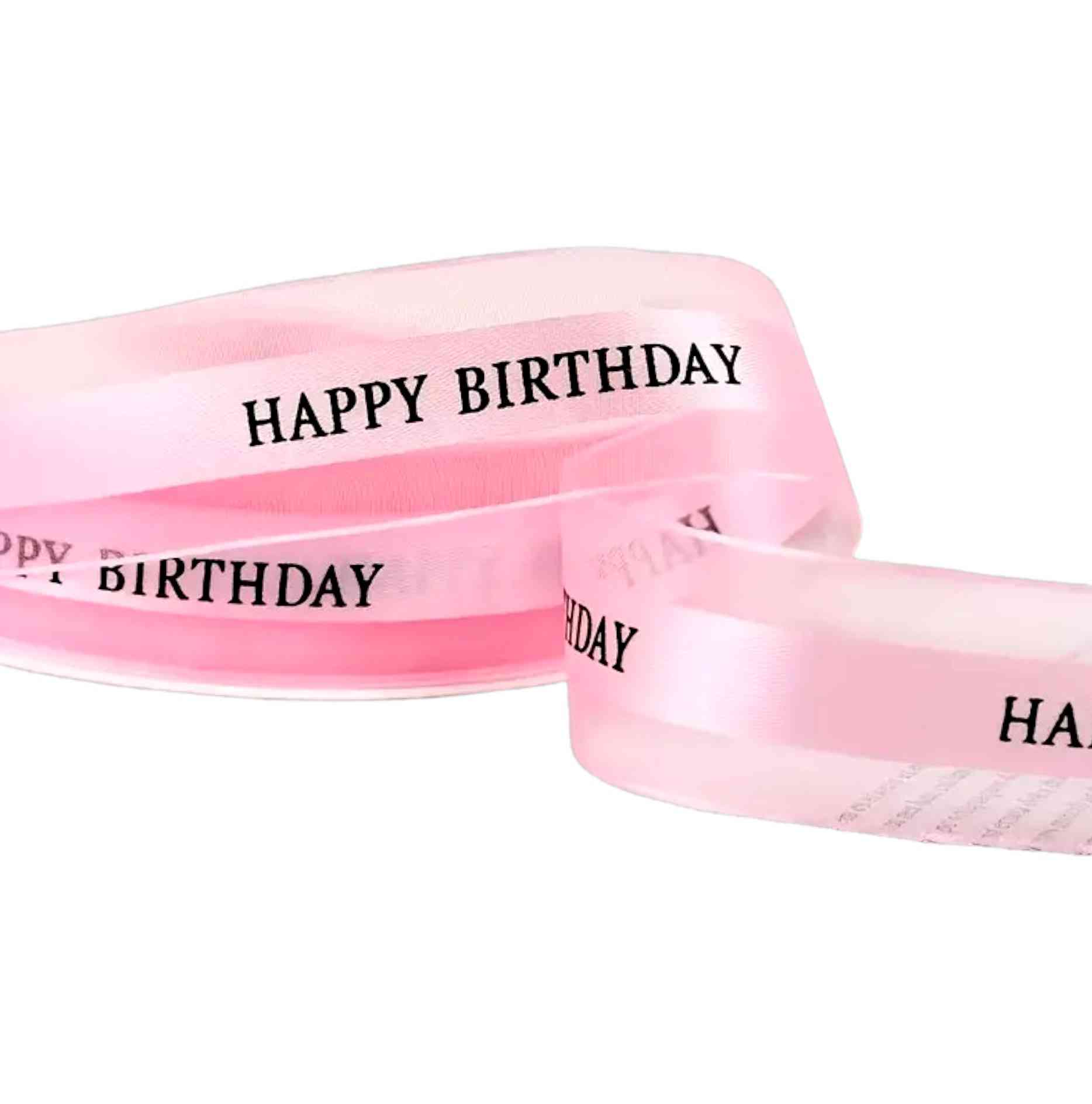 Baby pink mesh ribbon with black Happy Birthday text – 2.5 cm wide, ideal for pastel party cakes and wrapping.