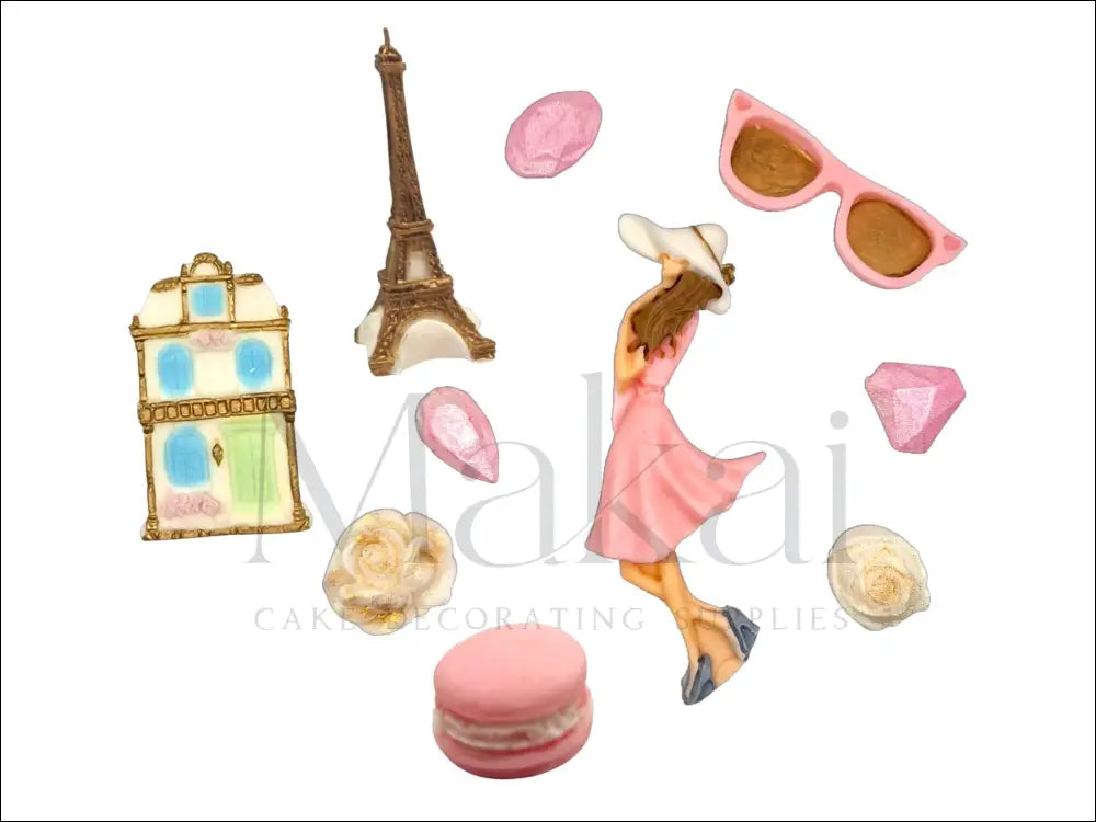 Paris-themed fondant cake decoration set with Eiffel Tower, Parisian building, stylish woman, macaron, sunglasses, roses, and gems.