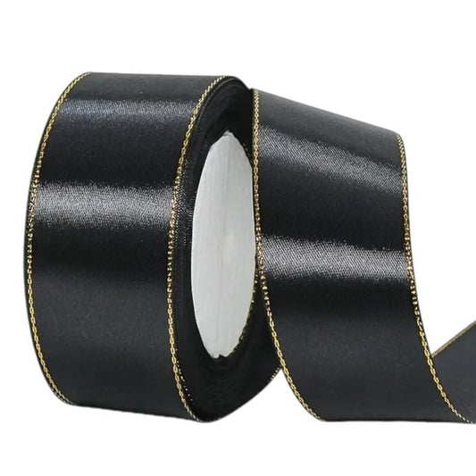 Black satin ribbon with metallic gold edge, 2.5 cm wide – perfect for cakes, crafts and elegant gift wrapping.