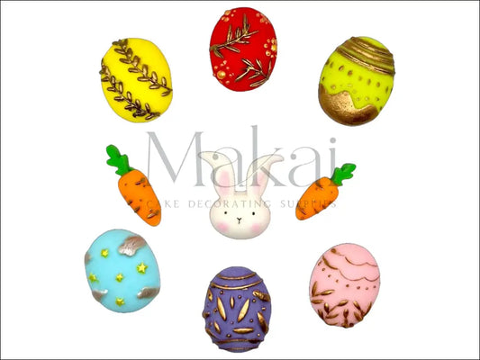 Fondant Easter set with a bunny face, carrots, and decorative eggs with gold accents for cake decoration.