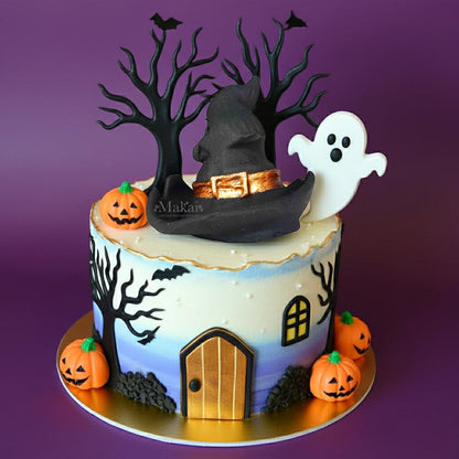 Purple and orange Halloween cake with witch hat and haunted house theme