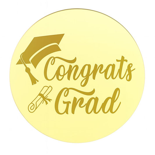 Round gold acrylic cake topper with “Congrats Grad” engraving, graduation cap and scroll icons