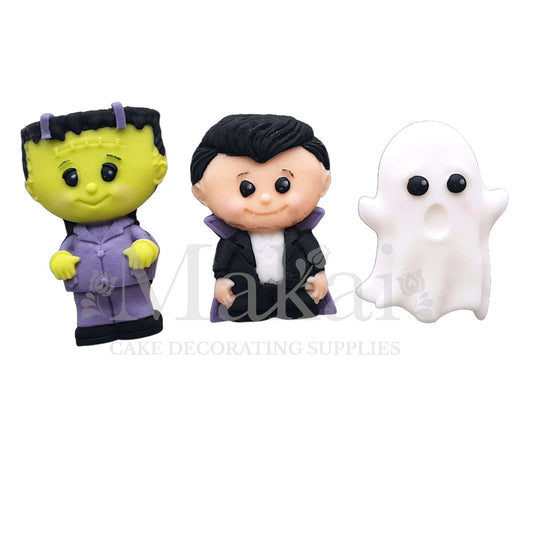 Three Halloween fondant cake toppers including Dracula, Frankenstein, and a white ghost, handmade edible decorations from Makai Cake Decorating Supplies.