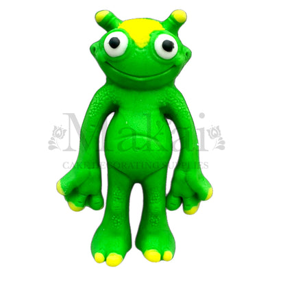 Green alien fondant cake topper with big eyes and yellow details – handmade edible decoration for space themed birthday cakes by Makai Cake Decorating Supplies