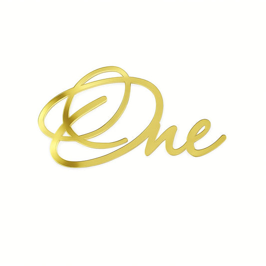 Gold acrylic cake topper spelling “ONE” in elegant script font