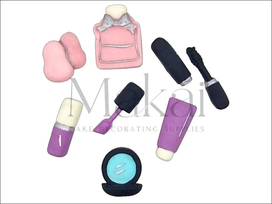 Pink fondant makeup essentials set with perfume, mascara, sponge, mirror, cream tube, and brush for cake decoration.
