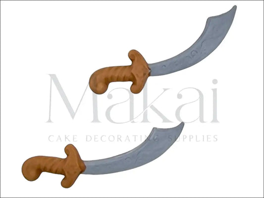 Pirate sword cake decoration set with brown hilt and grey blade.