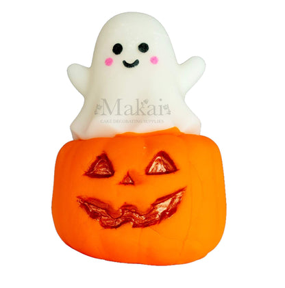 Edible fondant pumpkin and ghost Halloween cake topper with smiling face and gold details.