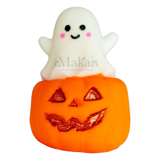 Edible fondant pumpkin and ghost Halloween cake topper with smiling face and gold details.