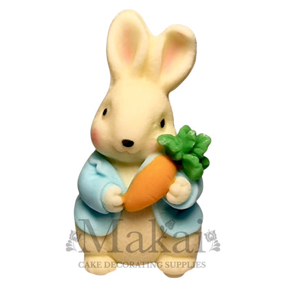 Edible rabbit cake topper with blue jacket and carrot—ideal for baby shower and garden-themed cakes.
