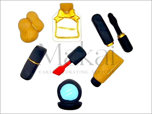 Red fondant makeup essentials set with perfume, mascara, sponge, mirror, cream tube, and brush for cake decoration.