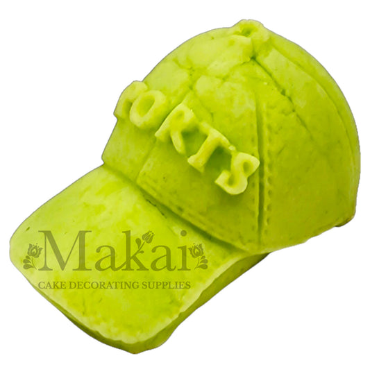Light‑green fondant sport cap with raised SPORTS text for athletic‑themed cakes.