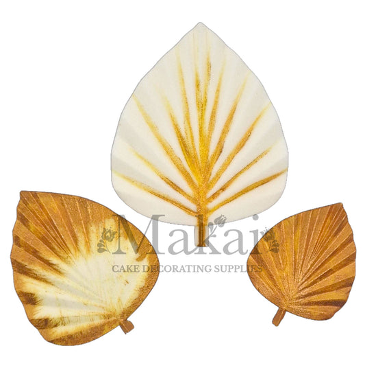 Edible white and gold leaf cake toppers in assorted shapes—ideal for elegant wedding or engagement cake decoration.