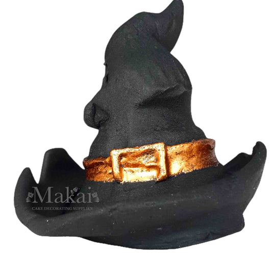 Black fondant witch hat cake topper with a gold buckle, side view – handmade Halloween cake decoration.