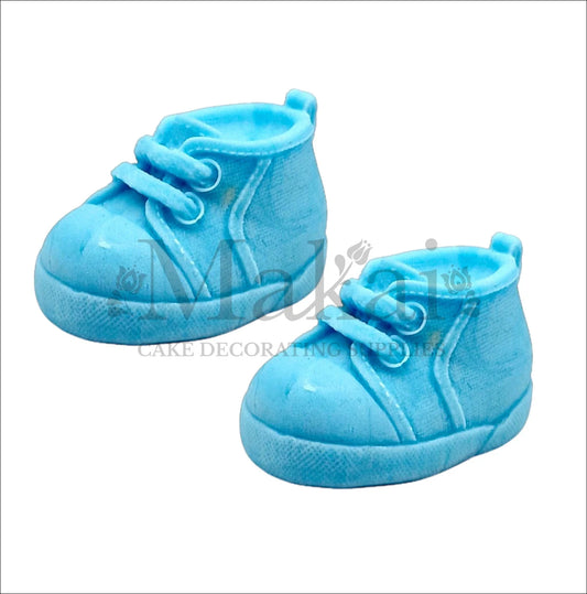 Edible blue fondant baby shoes cake topper pair for boy baby‑shower and first‑birthday cakes.
