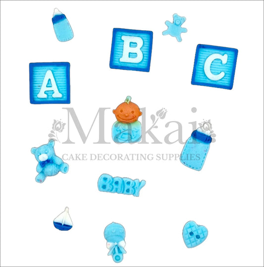 Edible baby boy cake topper set with blue alphabet blocks, baby bottle, teddy bear, rattle, boat, and cute details – perfect for baby showers or birthdays.