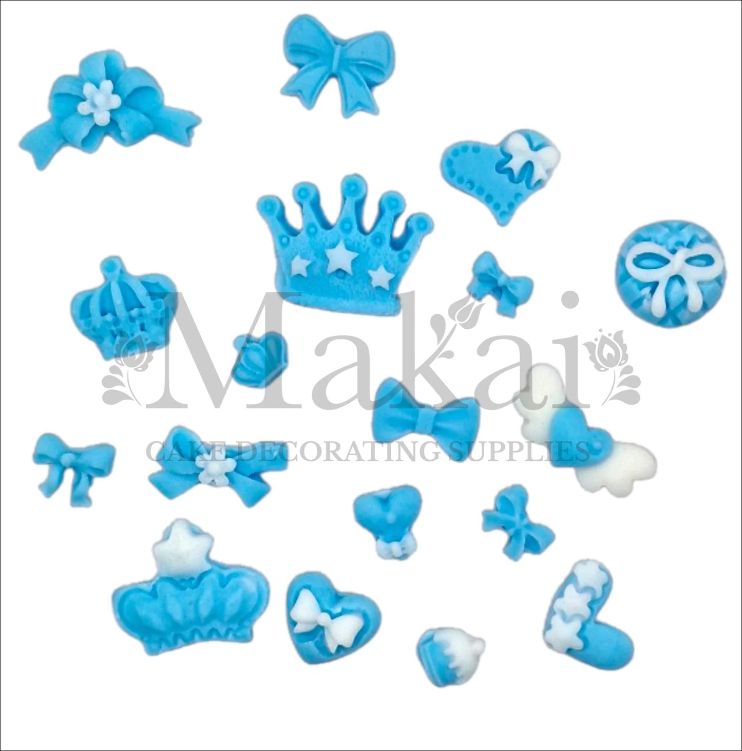 Set of edible blue fondant crowns, bows, hearts and baby accessories for prince‑themed cakes and cupcakes.