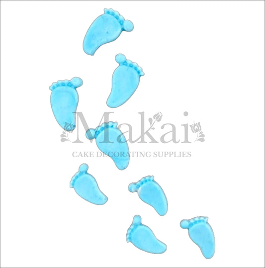 Blue baby boy footprint toppers arranged in a playful trail.