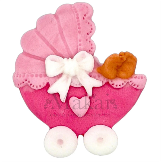 Edible pink pram cake topper with baby feet, lace canopy and bow for baby‑girl shower or gender‑reveal cakes.
