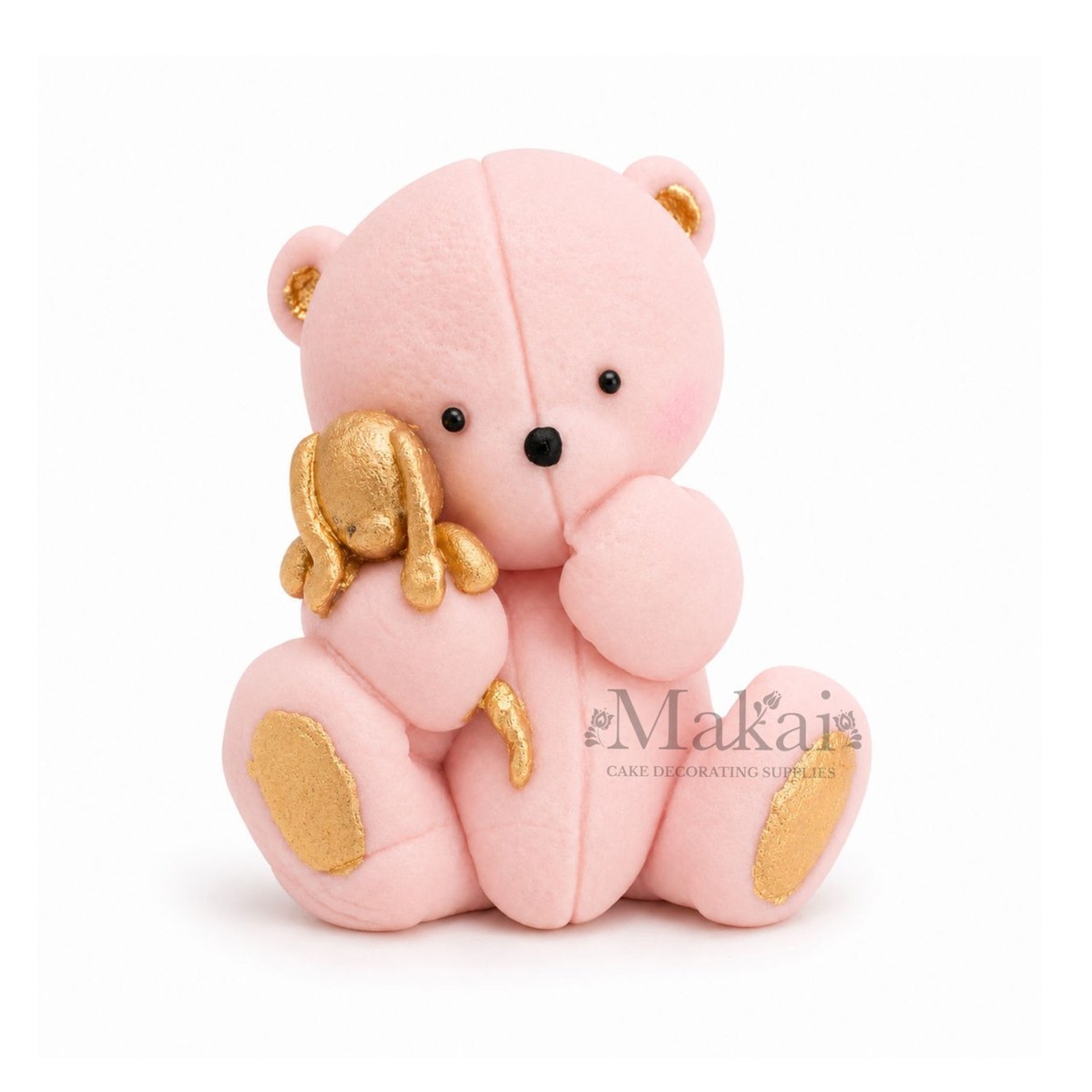 Baby pink teddy bear fondant cake topper holding a gold bunny decoration, front view