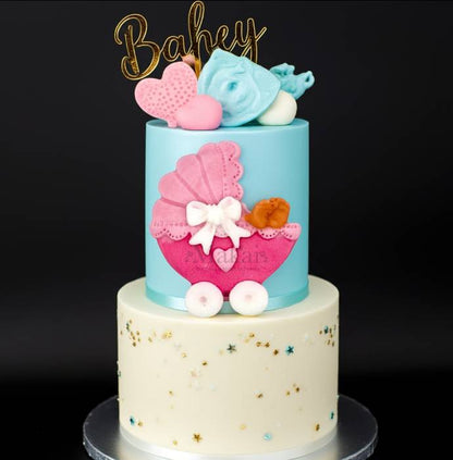 Baby shower cake decorated with a pink fondant pram topper, gold “Baby” cake topper, and pastel decorations – Makai Cake Decorating Supplies