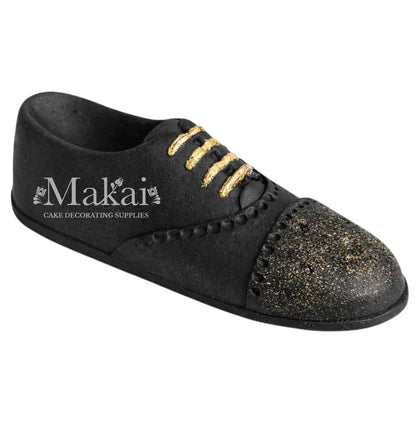 Black gentleman shoe cake topper with gold details, elegant fondant decoration for birthday and celebration cakes