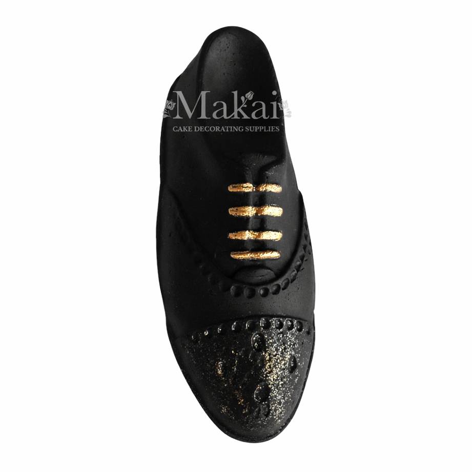 Black gentleman shoe fondant cake topper with gold lace details, side view, elegant birthday cake decoration