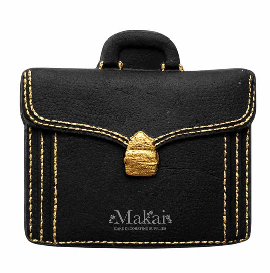 Black gentleman briefcase cake topper with gold details for elegant celebration cakes