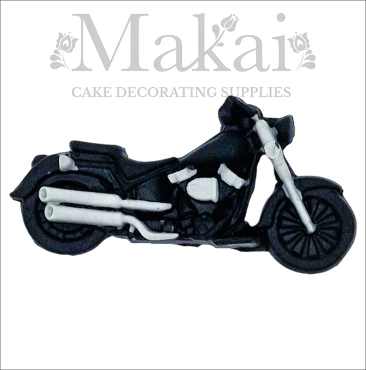 Edible black fondant motorbike cake topper with silver pipes, ideal for biker and racing cakes.