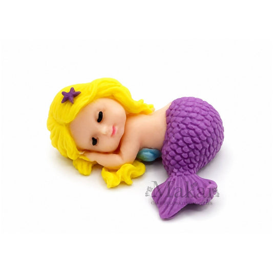 Sleeping mermaid baby edible cake topper with purple tail and blonde hair, ideal for fantasy and underwater-themed cakes.