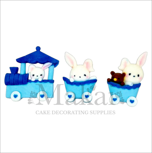 Edible blue bunny train cake topper set with locomotive, carriages and baby rabbits for baby‑boy shower cakes.