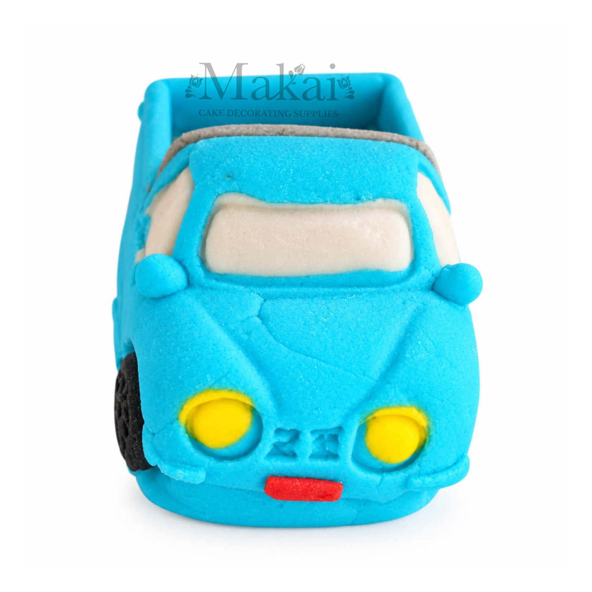 Front view of blue fondant pickup truck cake topper with yellow headlights