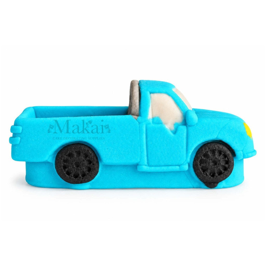 Side view of blue 3D fondant pickup truck cake decoration