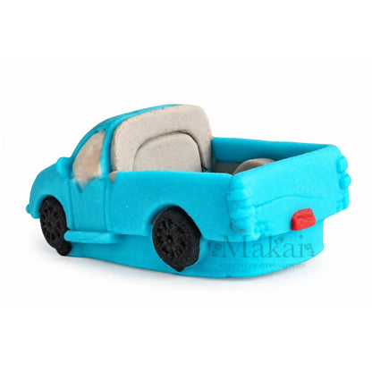 Rear view of blue fondant pickup truck cake topper with open truck bed