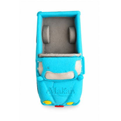 Top view of blue 3D fondant pickup truck cake topper showing the open truck bed
