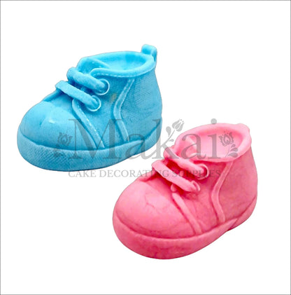 Edible fondant blue and pink baby shoes cake topper set for gender reveal and baby‑shower cakes.