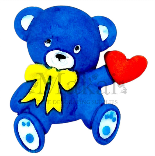 Edible blue teddy bear cake topper with red heart and yellow bow – perfect for baby showers, birthdays, and special occasions.