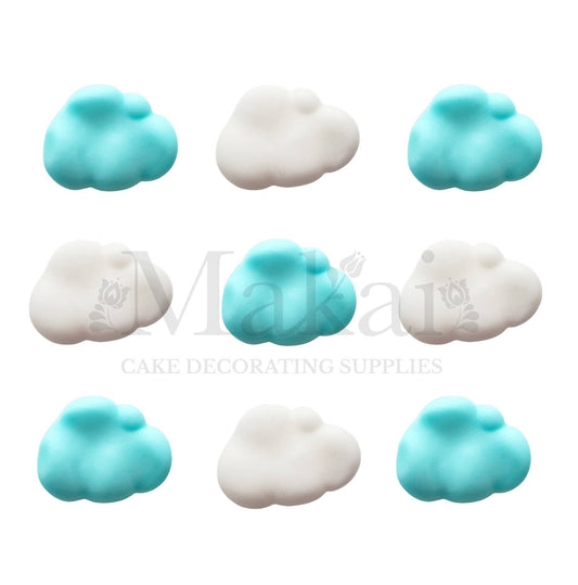 Pastel blue and white fondant cloud decorations arranged in a nine-piece set.