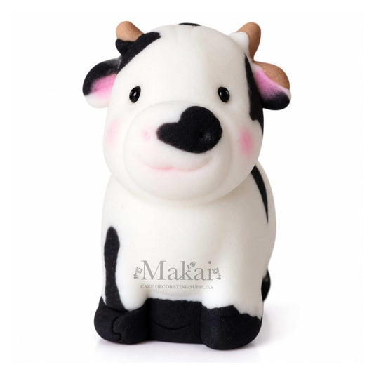 Large black and white cow fondant cake topper for farm themed birthday cakes